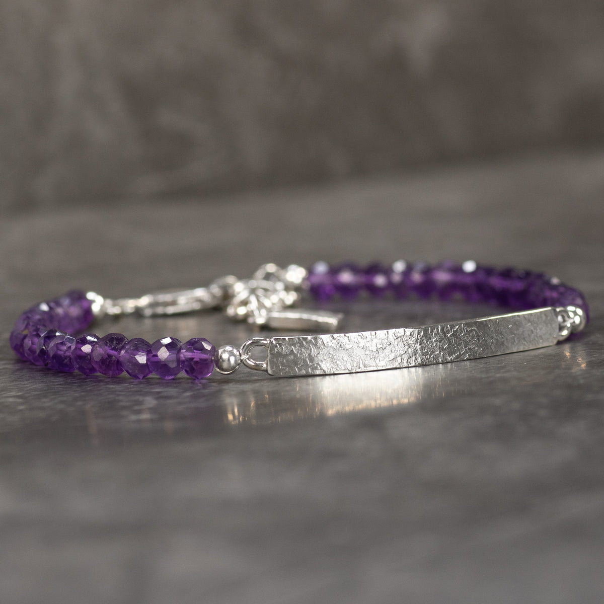 Handmade Amethyst gemstone bracelet with textured Argentium Silver bar and faceted purple beads