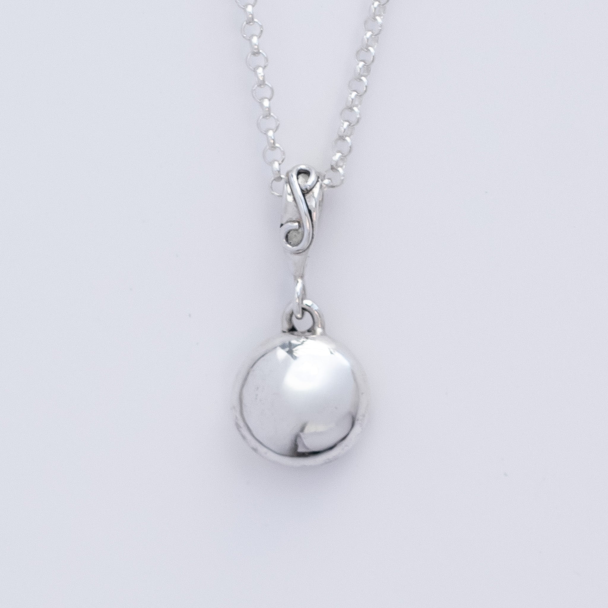 Argentium Silver Pebble Penant with a smooth bright white silver polish. On a mini silver belcher chain. 
