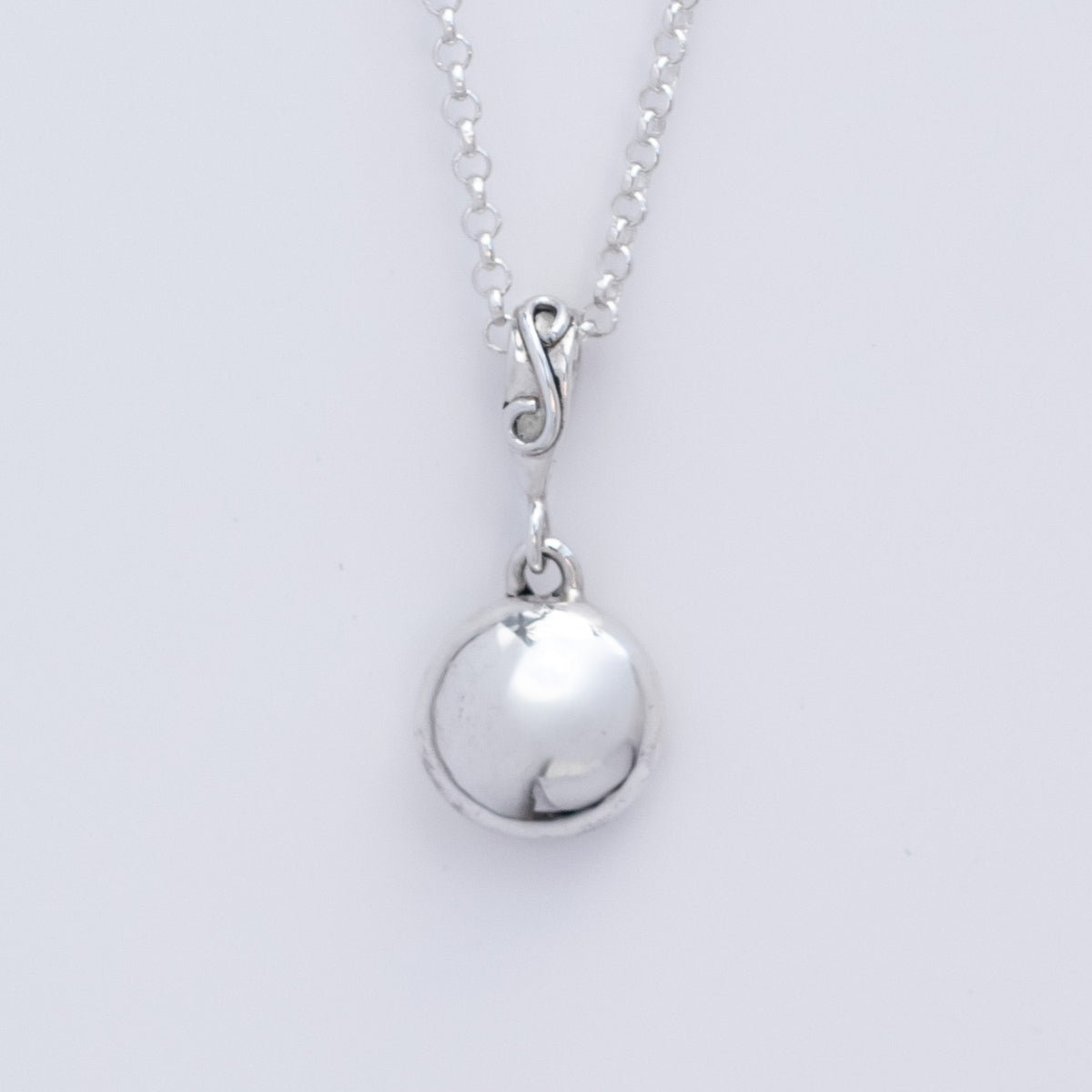 Argentium Silver Pebble Penant with a smooth bright white silver polish. On a mini silver belcher chain. 