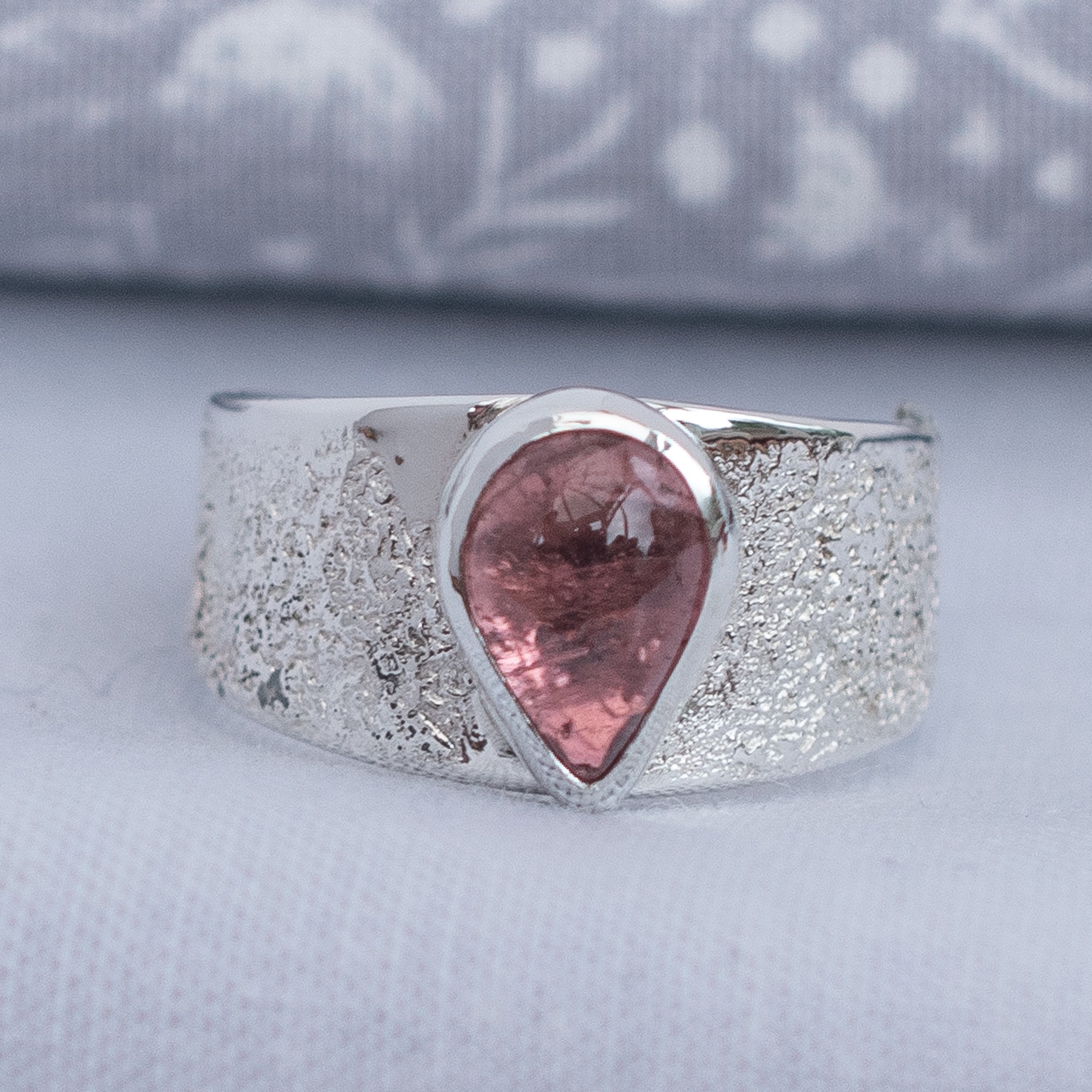 Natural pink pear-shaped tourmaline wide band ring in textured Argentium silver