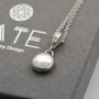 Smooth Silver pebble pendant with a detailed handmade swirl bail on a sterling silver chain. 