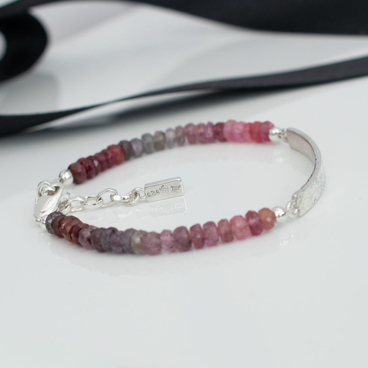 Handcrafted Argentium silver clasp and adjustable extension chain with small handmade silver charm on spinel bracelet