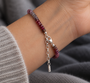 Close-up of handmade textured Argentium 940 silver bar on natural rainbow spinel bracelet