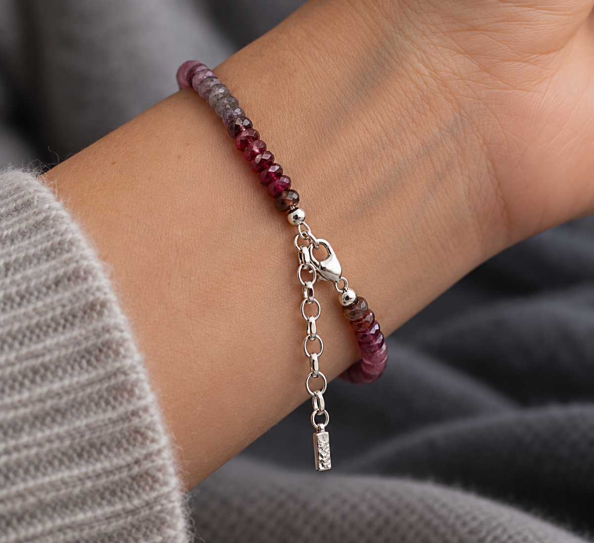 Close-up of handmade textured Argentium 940 silver bar on natural rainbow spinel bracelet