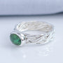Handmade green tourmaline ring showing detailed woven silver band
