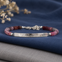 Artisan rainbow spinel gemstone bracelet featuring a gently curved textured silver bar and faceted natural gemstones