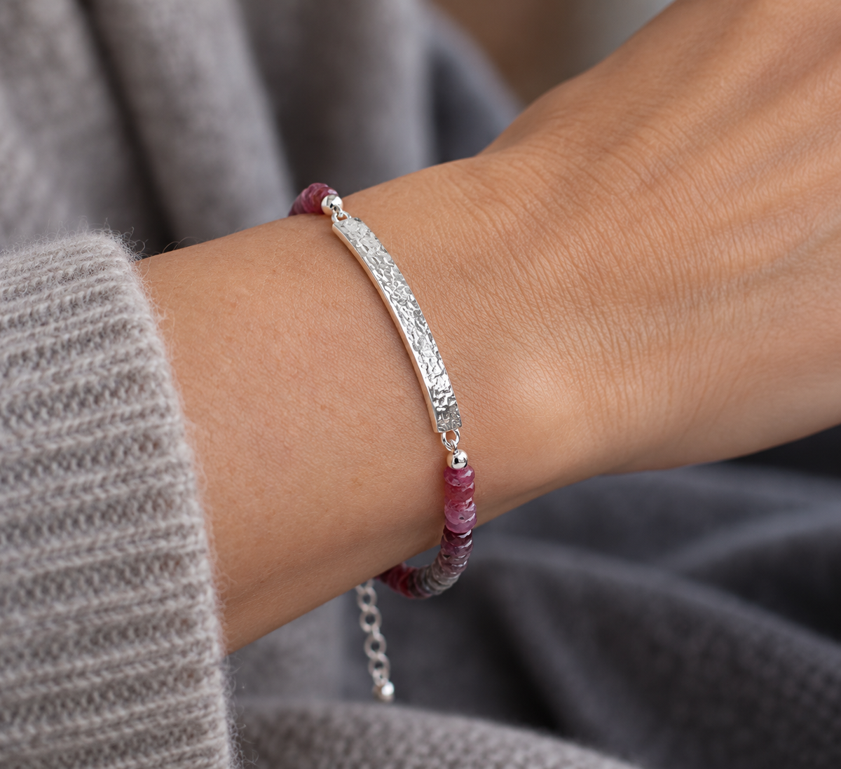 Natural rainbow spinel gemstone bracelet in muted pink, red, mauve and earthy tones with handcrafted silver bar