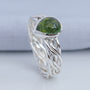 Handwoven silver ring band with crossing strands and pear-shaped tourmaline