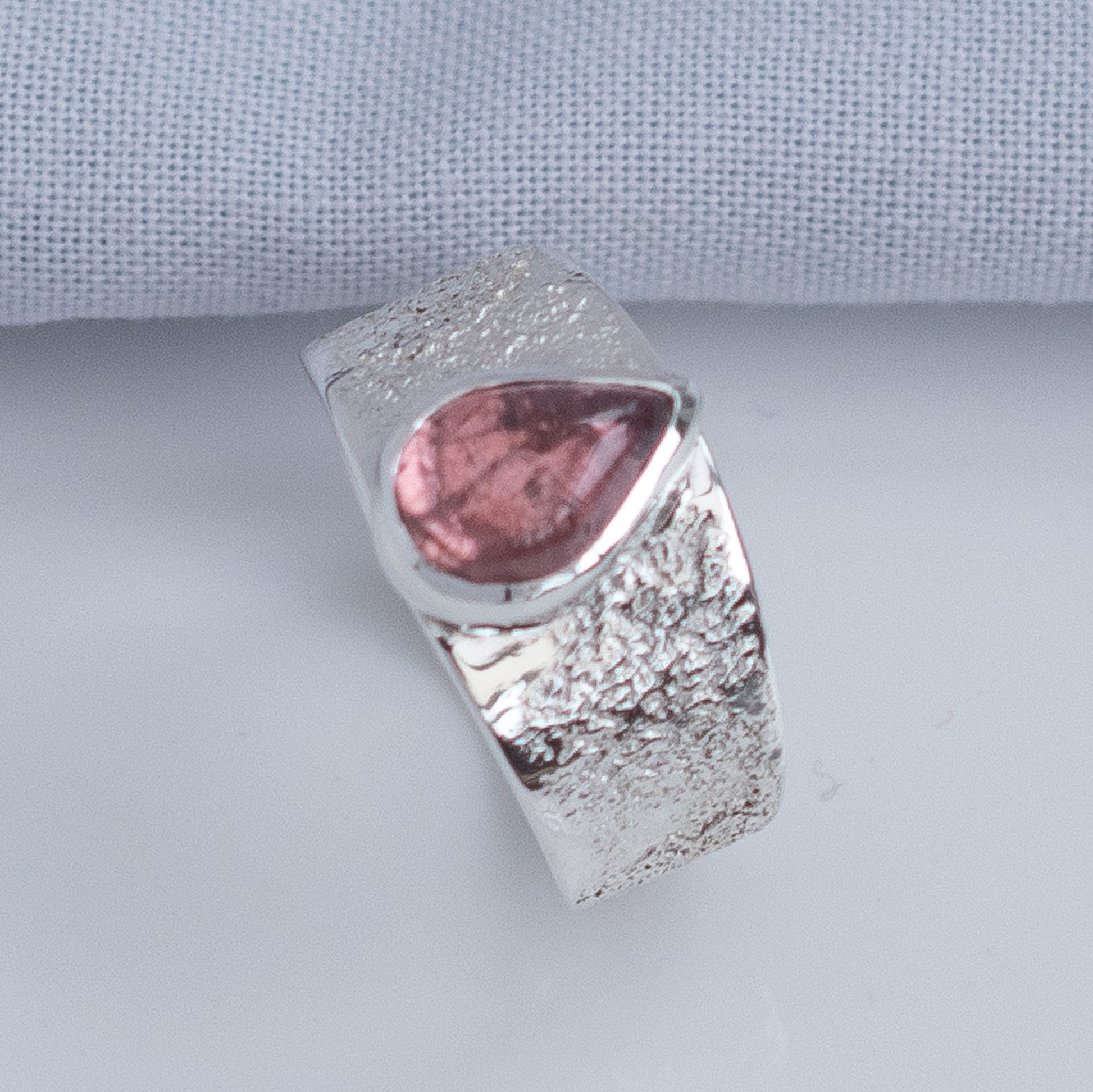 Wide textured silver ring band tapering at the back for comfort, UK size O