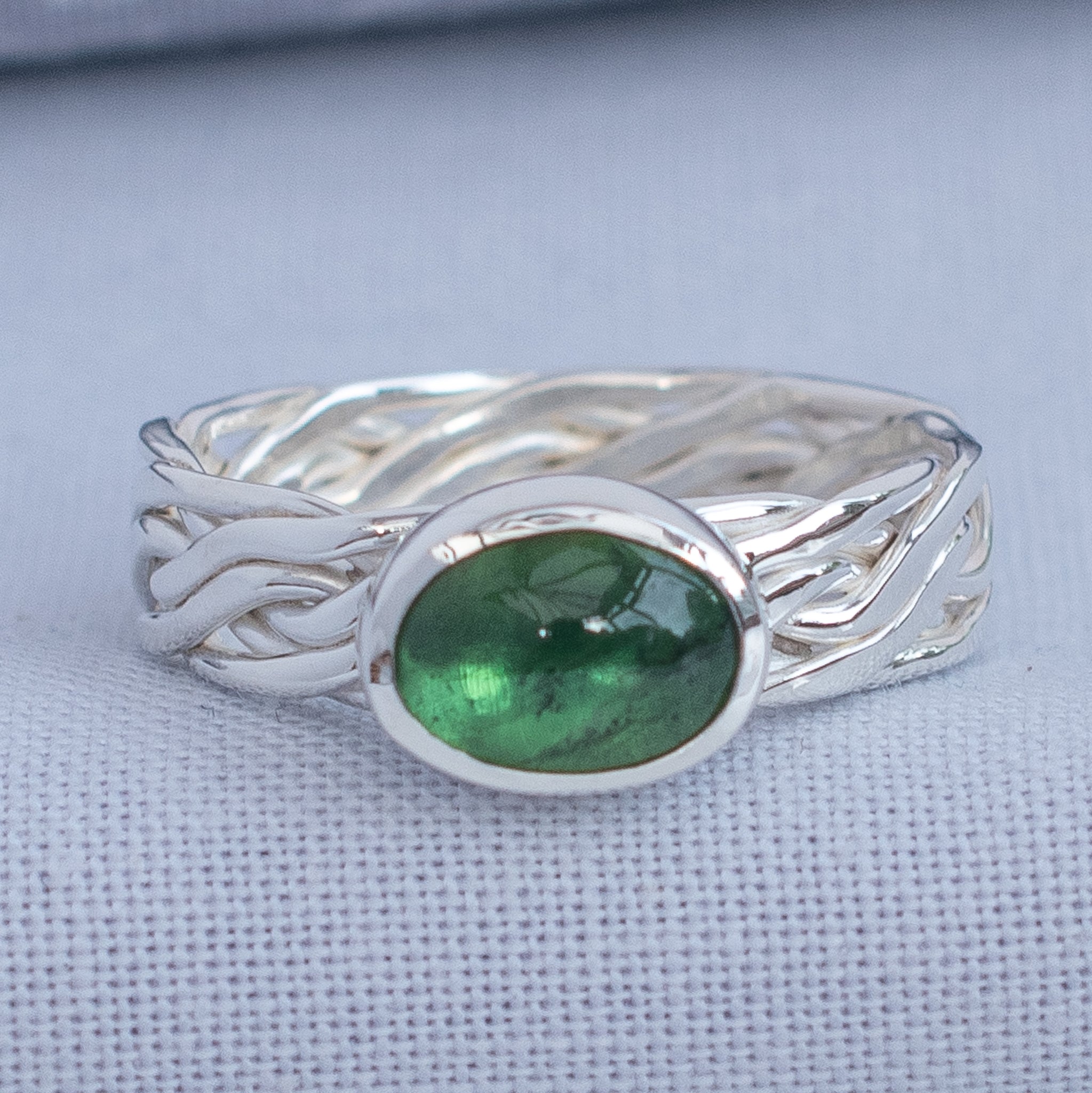 Handmade oval green tourmaline ring with woven Argentium silver band, UK size L